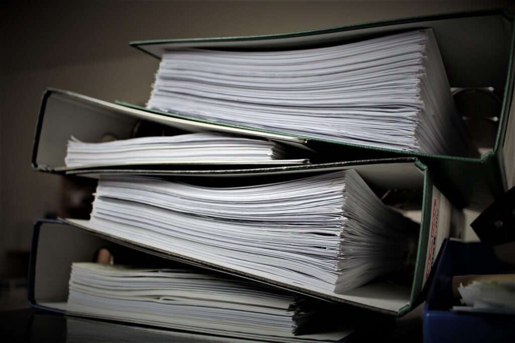 Stack of notebooks filled with papers